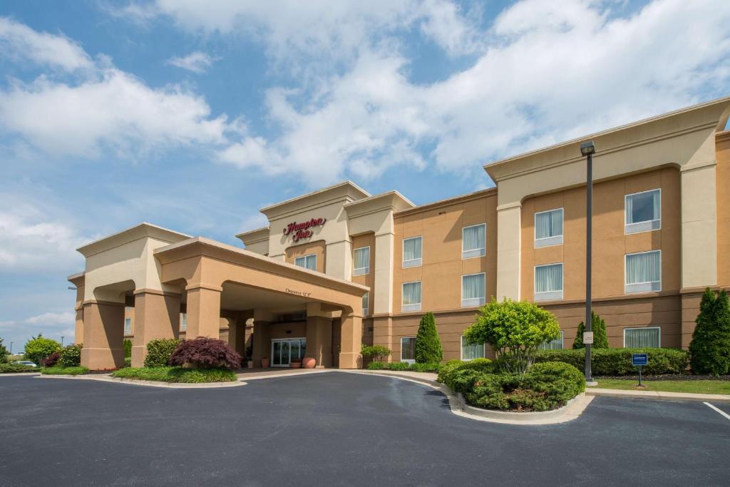 a front view of a hotel with a parking lot at Hampton Inn Easley in Easley