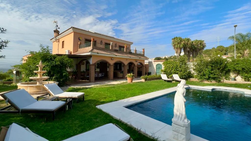 een huis met een zwembad en een huis bij Villa Huerta del Sur - Piscina privada y barbacoa in Alhaurín el Grande