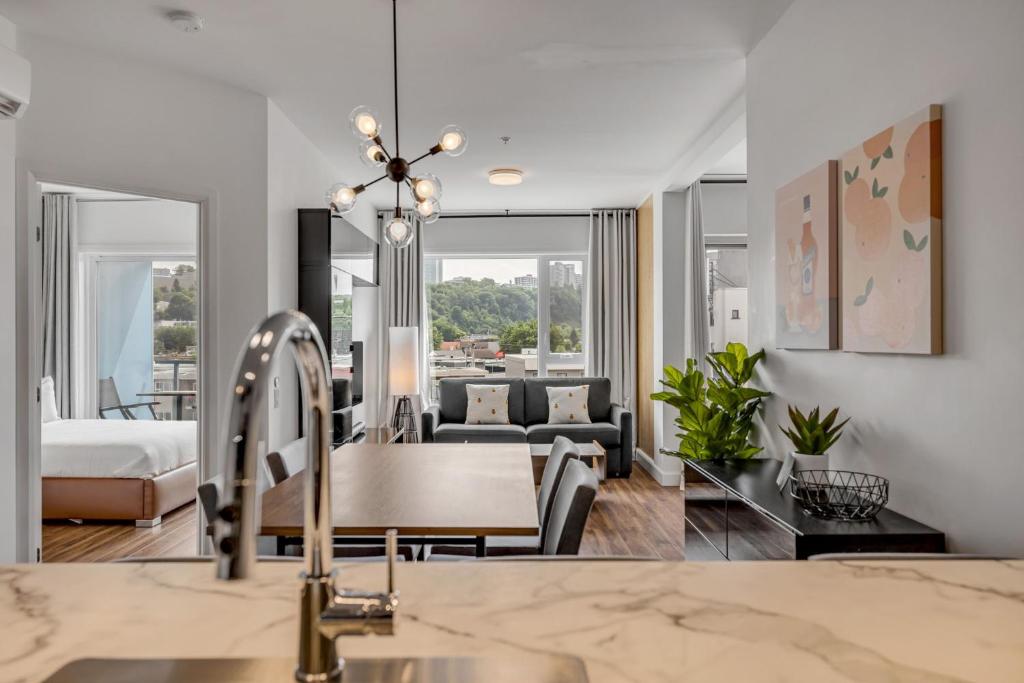 a kitchen and living room with a sink at Initial / Spritz / Downtown Qc +STAT in Quebec City