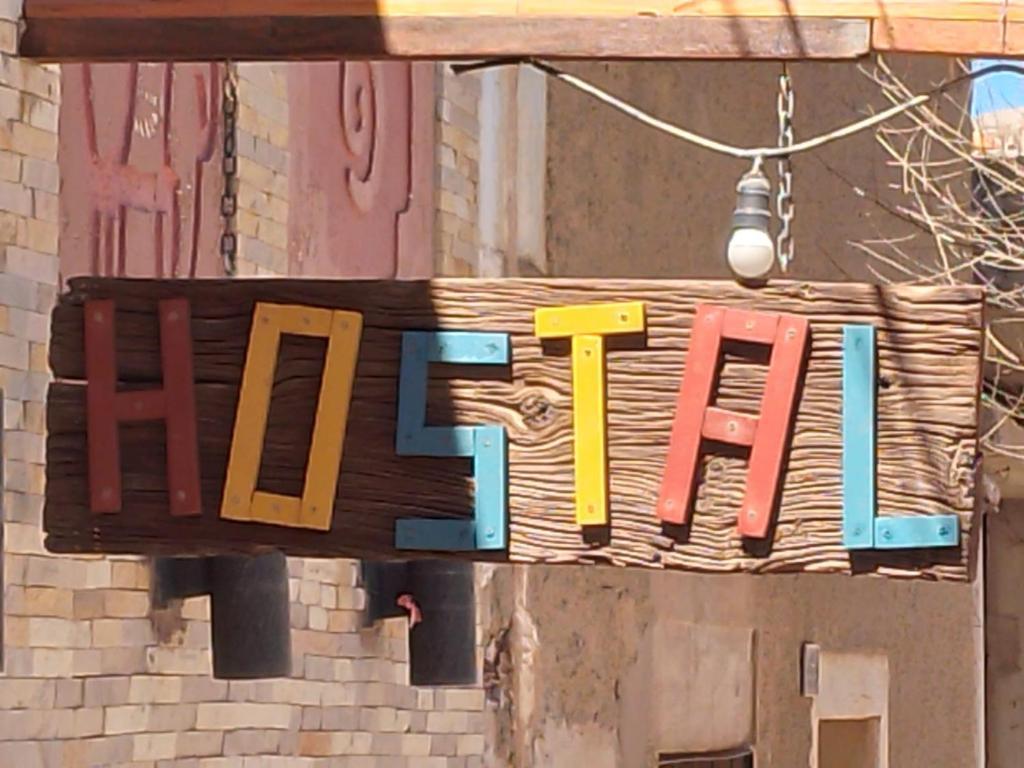 a sign that says fire hanging from a building at Hostal Casa Grande in Villazón