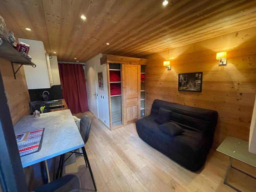 a living room with a couch and a table at LOUE STUDIO MEGEVE in Megève