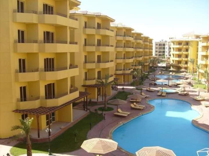 a resort with a swimming pool and some buildings at Hurghada British compound in Hurghada