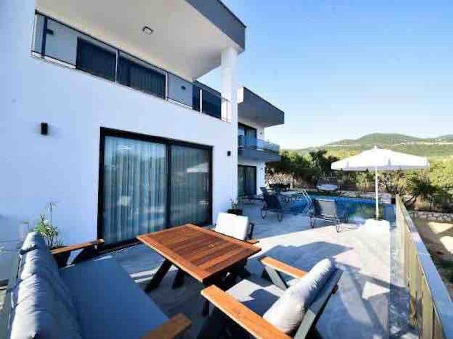 una casa con un patio con mesa y sillas en Villa Mi Kasa, en Kas