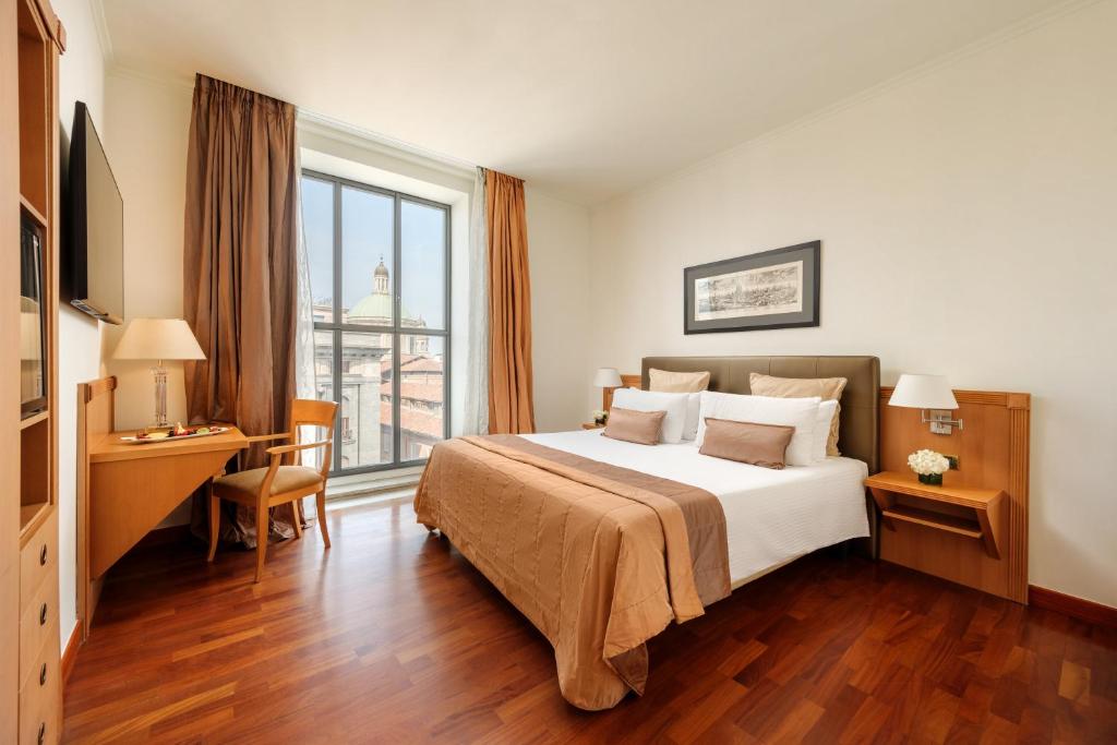 Postel nebo postele na pokoji v ubytování Hotel Dei Cavalieri Milano Duomo
