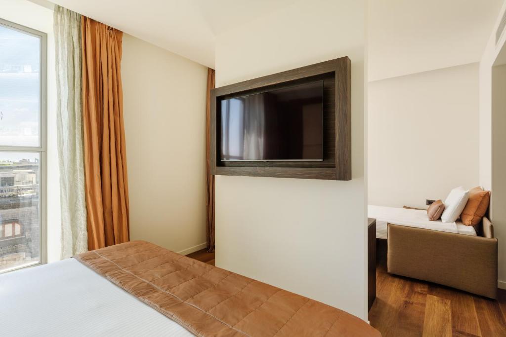 Postel nebo postele na pokoji v ubytování Hotel Dei Cavalieri Milano Duomo