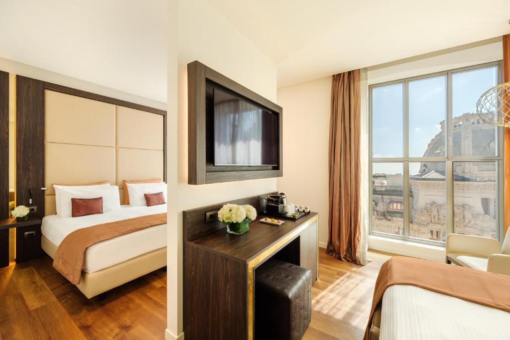 Postel nebo postele na pokoji v ubytování Hotel Dei Cavalieri Milano Duomo