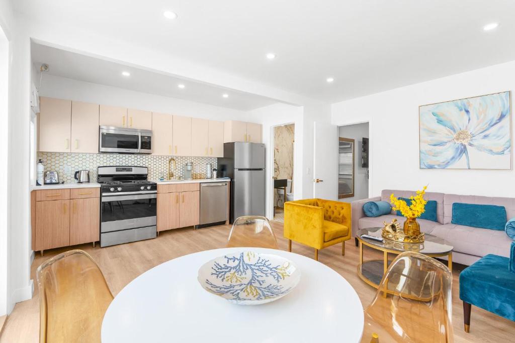 a kitchen and living room with a table and chairs at 316 Footloose #3 in Hollywood
