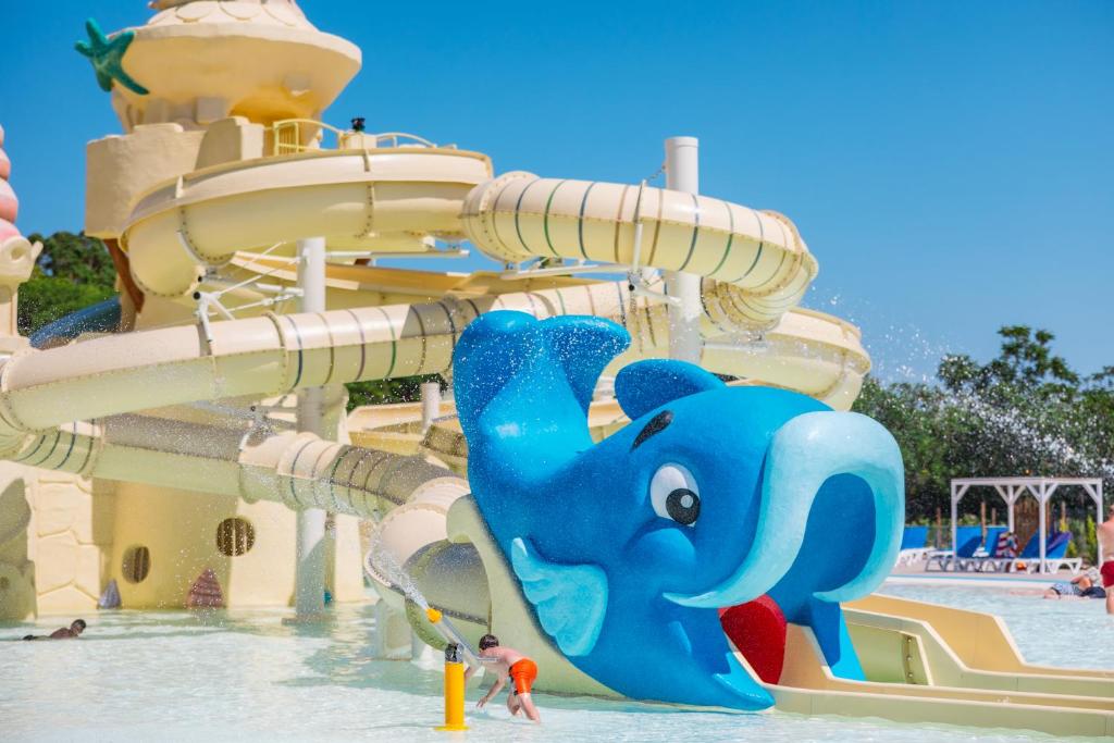 a water park with a blue elephant on a water slide at Camping Village Le Capanne in Marina di Bibbona