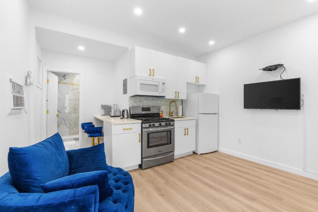 a living room with a blue couch and a kitchen at 316 Footloose #1 in Hollywood