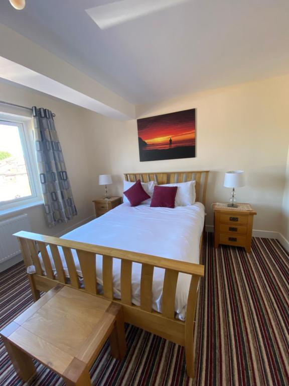 a bedroom with a large bed and a window at Plumpton Walk in Canterbury