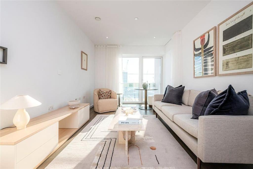 a living room with a couch and a table at Modern Buckingham Palace Apartment in London