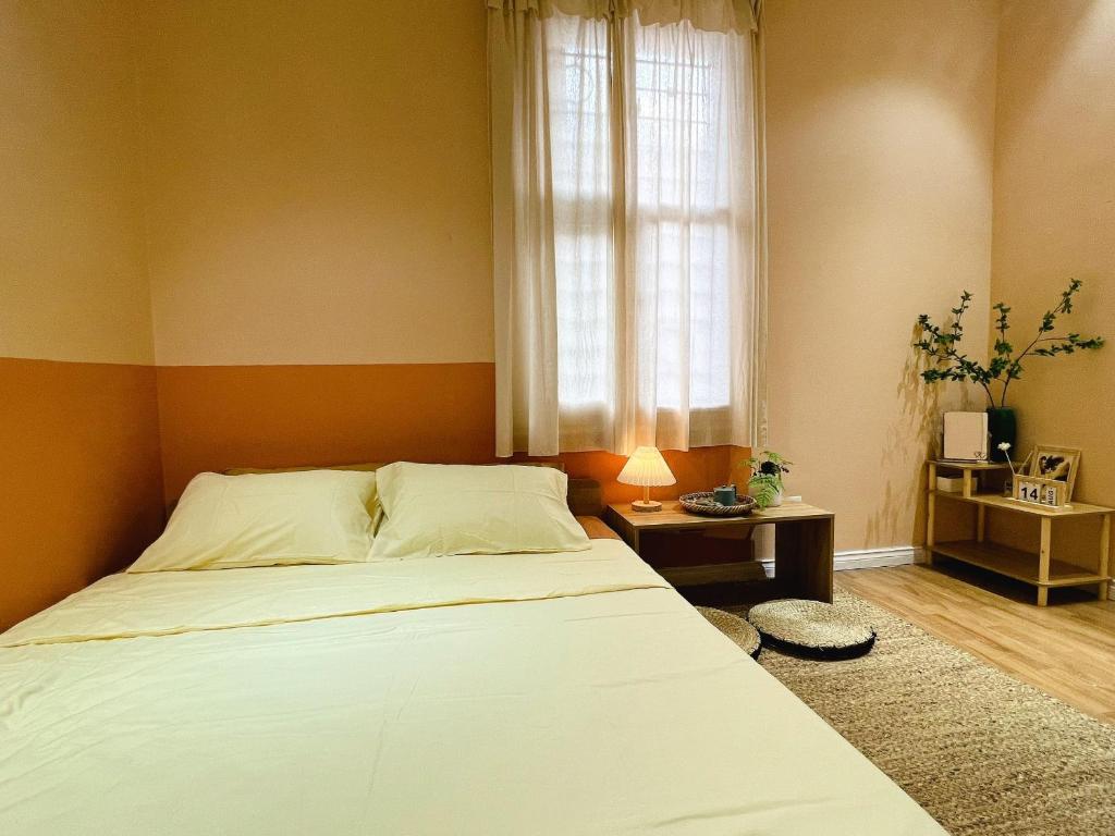 a bedroom with a large bed and a window at DAISY'S STAY in Hanoi