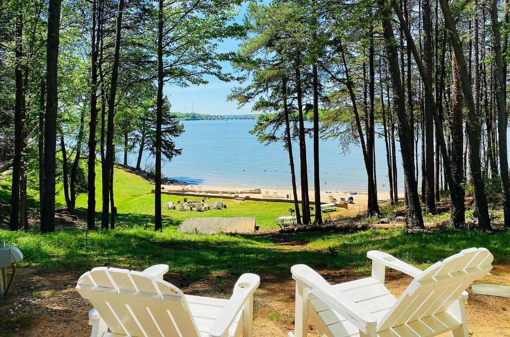 two white chairs sitting in front of a beach at Long Cove Resort and Marina in Charlotte