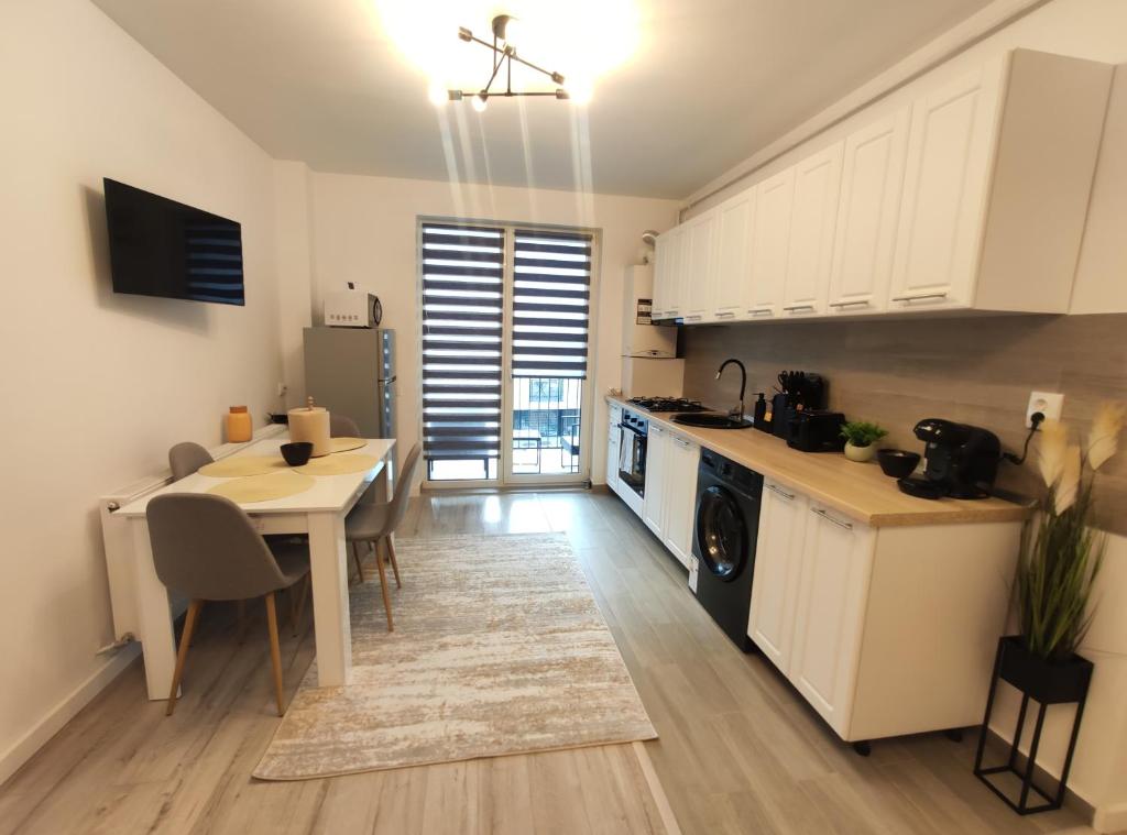 a kitchen with a table and a dining room at The Nest in Floreşti