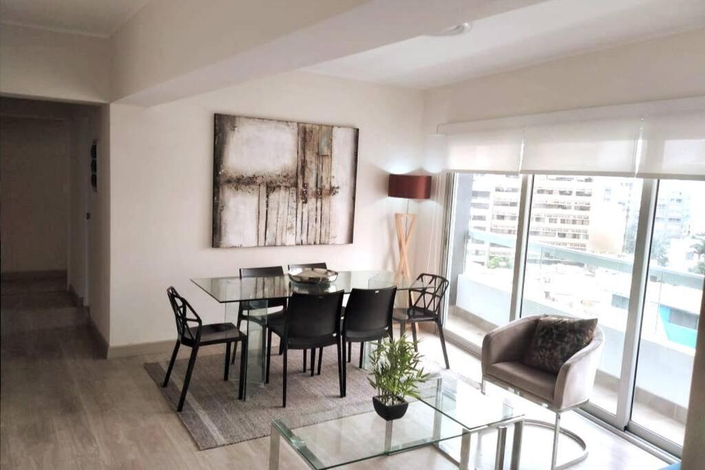 a living room with a dining room table and chairs at MLA apartments - Reducto 360 in Lima