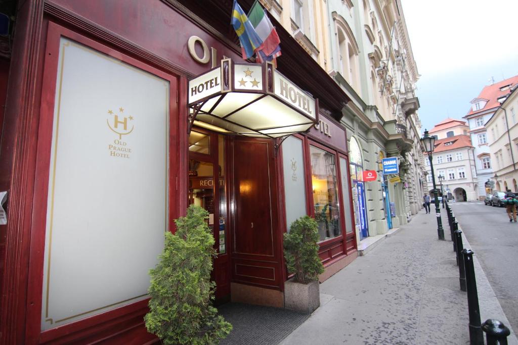 a building with a sign on the side of a street at Old Prague Hotel in Prague