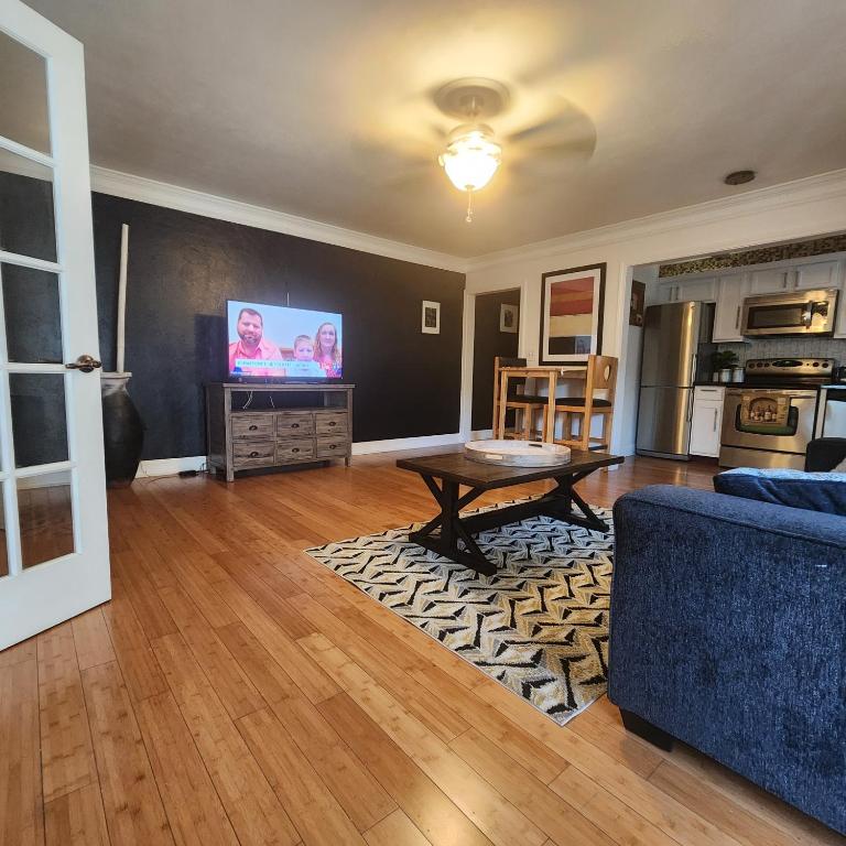 a living room with a couch and a table and a tv at Cozy View Downtown Atlanta Condo in Atlanta