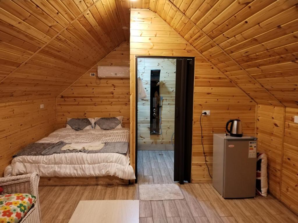 a bedroom with a bed in a wooden cabin at Widian al-sham huts in Jerash