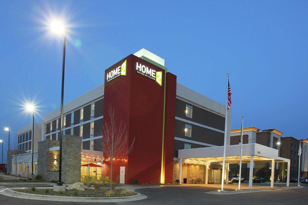 a hotel with a sign on the front of a building at Home2 Suites By Hilton Nampa in Nampa