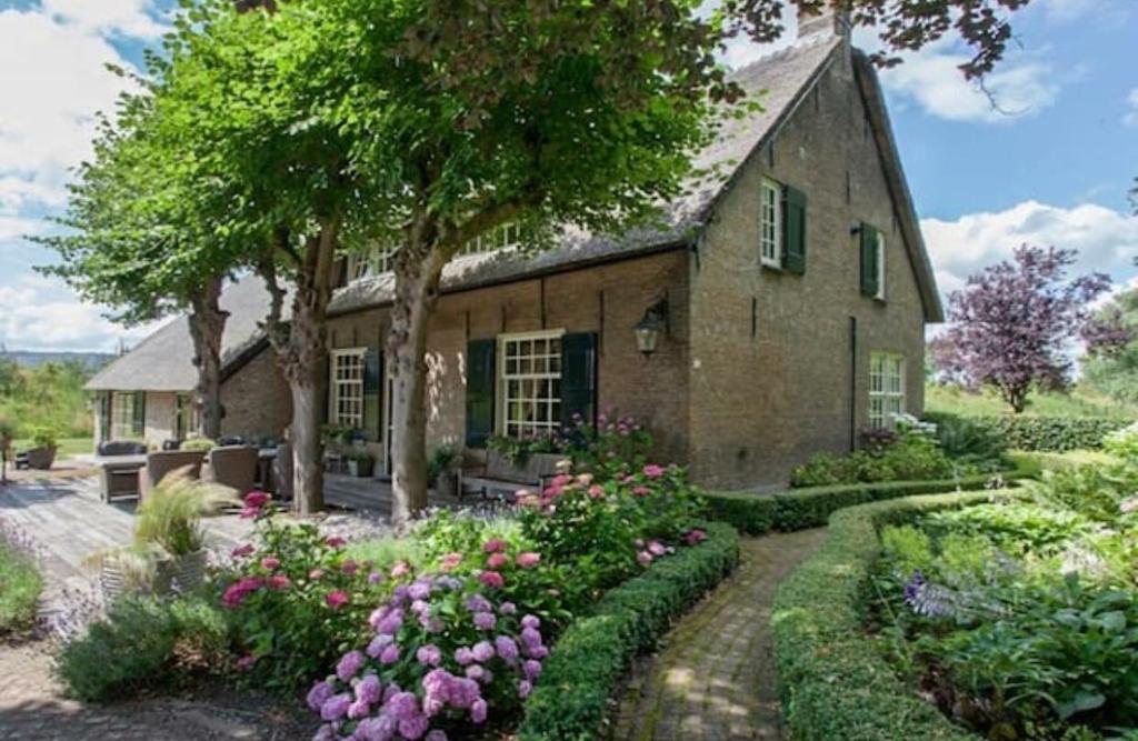 a stone house with a garden in front of it at Filion's Place in Roosendaal