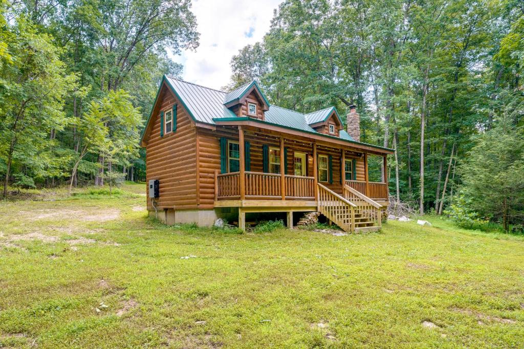 a log cabin in the woods with a large yard at Marlinton Cabin Rental with Greenbrier River Access! in Marlinton