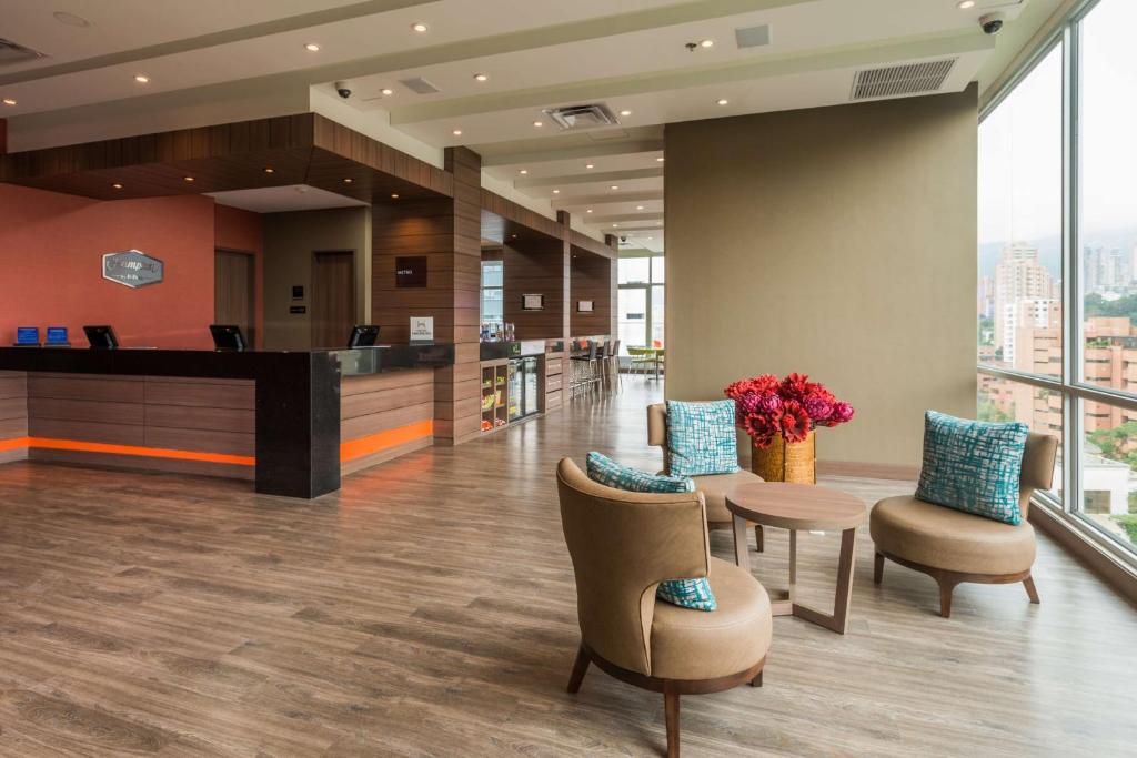 an office lobby with chairs and a reception desk at Hampton By Hilton Bogota Airport in Bogotá