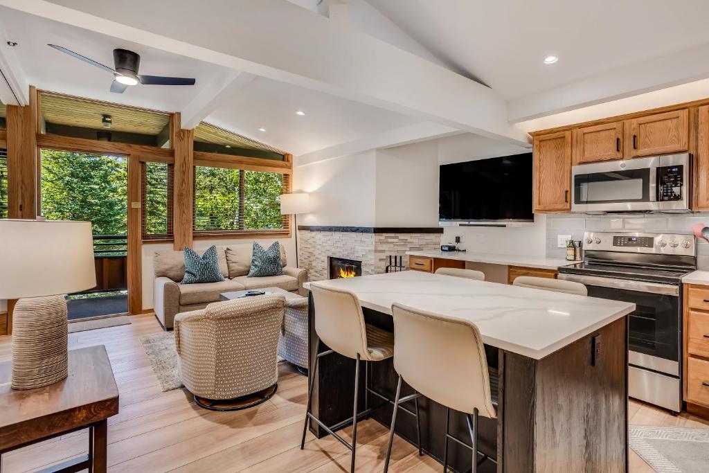 a kitchen and living room with a table and chairs at Laurelwood Condominiums 211 in Snowmass Village