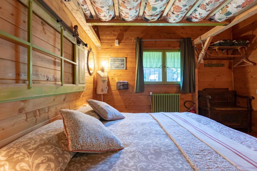 a bedroom with a bed with two pillows at La Tana dello Scoiattolo - Adults Only in Murazzano