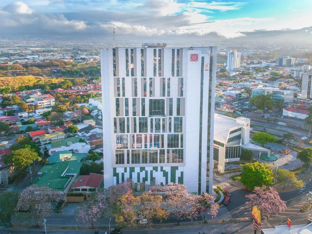 an aerial view of a tall building in a city at Hilton Garden Inn San Jose La Sabana, Costa Rica in San José