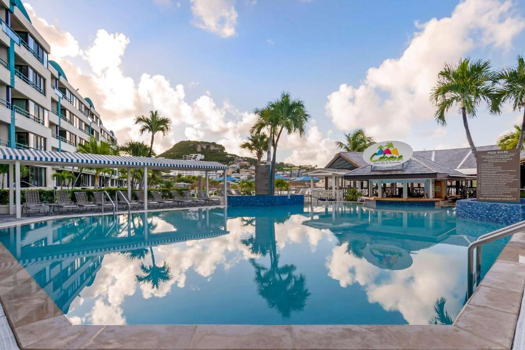 a pool at a resort with palm trees at Hilton Vacation Club Royal Palm St Maarten in Simpson Bay