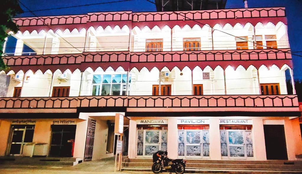 a building with a motorcycle parked in front of it at Hotel MSD Niwas in Mandāwa