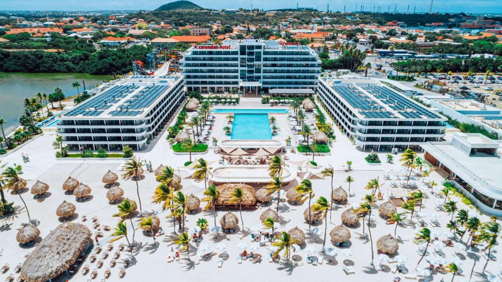 an aerial view of a resort with a pool and buildings at Mangrove Beach Corendon Curacao All-Inclusive Resort, Curio in Willemstad