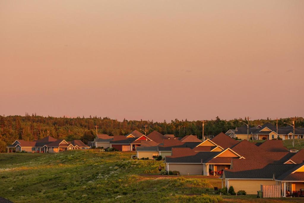 un grupo de casas en un campo con árboles en The Gables of PEI en Stanley Bridge