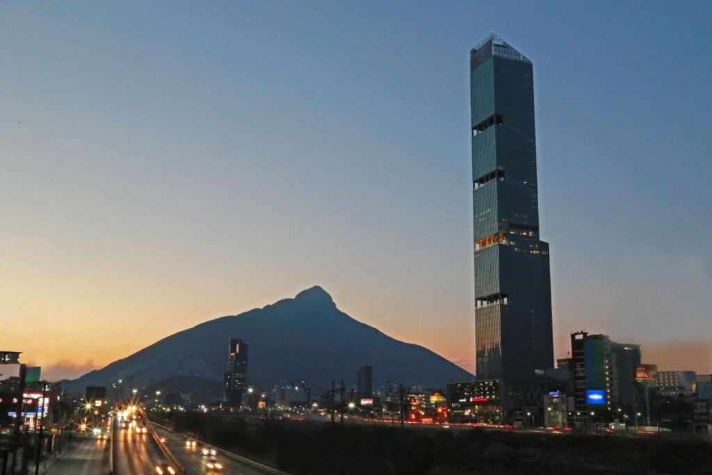 a view of a city with a mountain in the background at Hilton Garden Inn Monterrey Obispado in Monterrey