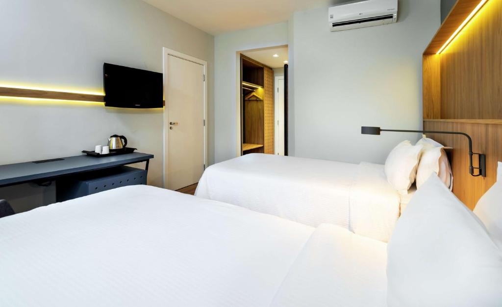Cama o camas de una habitación en Hampton by Hilton Guarulhos Airport
