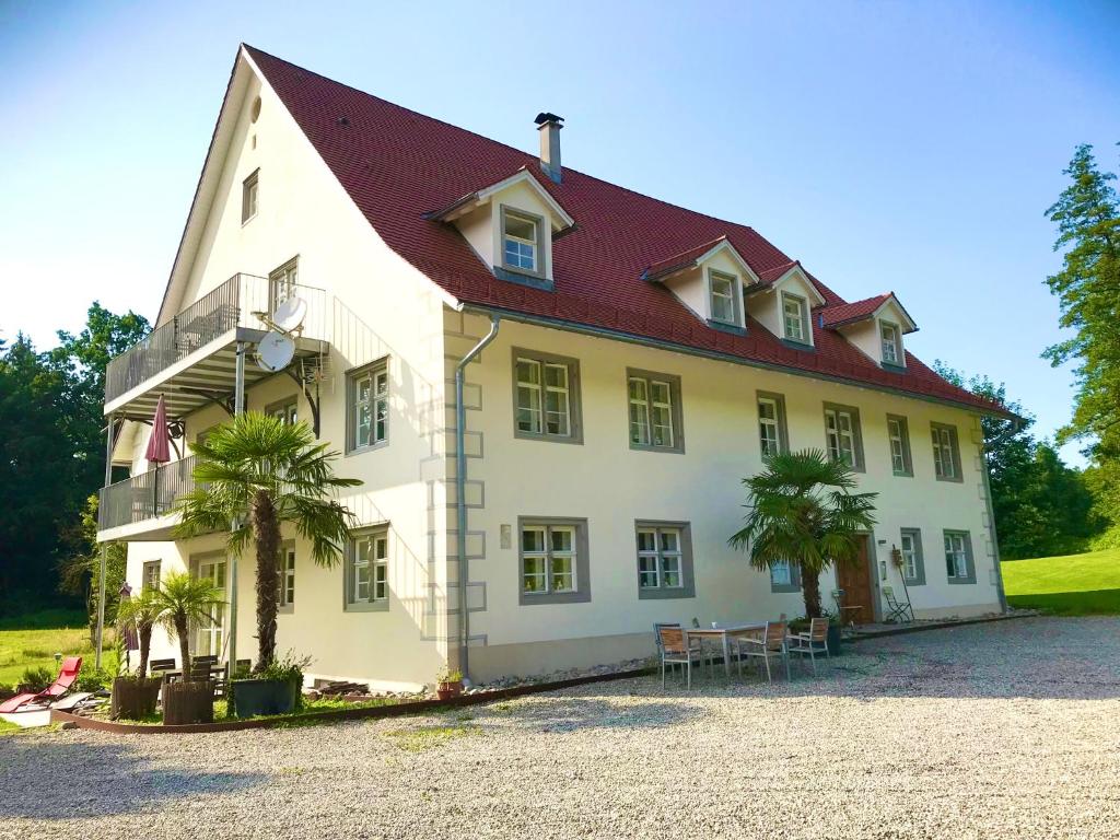 a large white house with a red roof at Goldschmiedsmühle in Lindau
