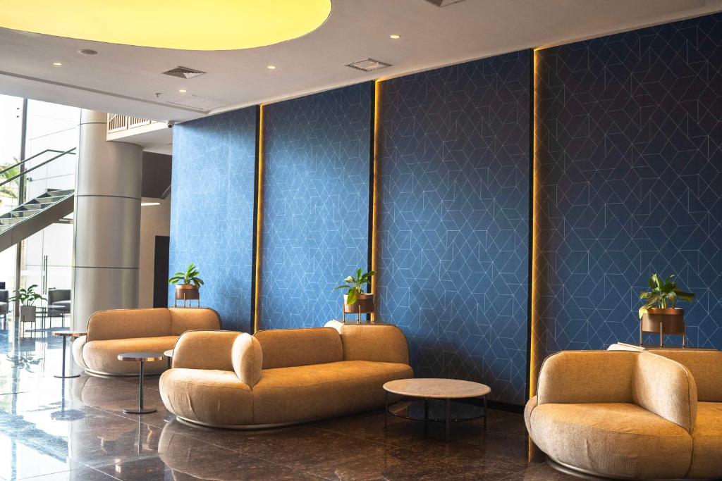 a lobby with couches and a blue wall at Doubletree By Hilton Trujillo in Trujillo