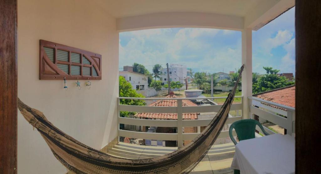 eine Hängematte auf einem Balkon mit Aussicht in der Unterkunft Pousada D Italia in São José da Coroa Grande