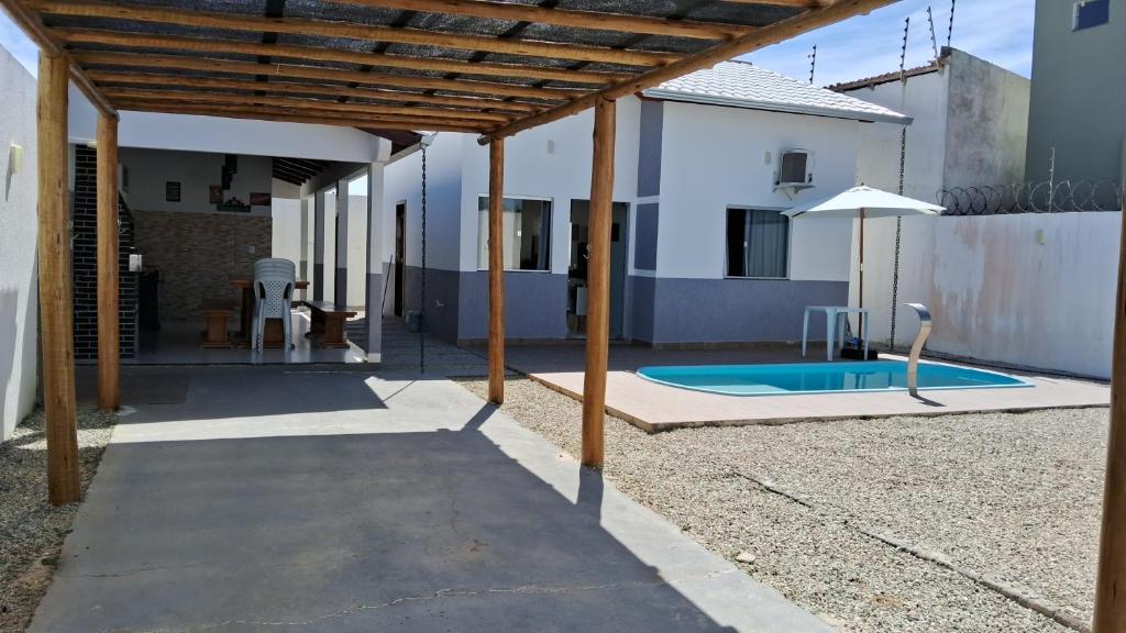 a patio with a swimming pool in a house at Casa com piscina e espaço gourmet a 30m da praia! in Alcobaça
