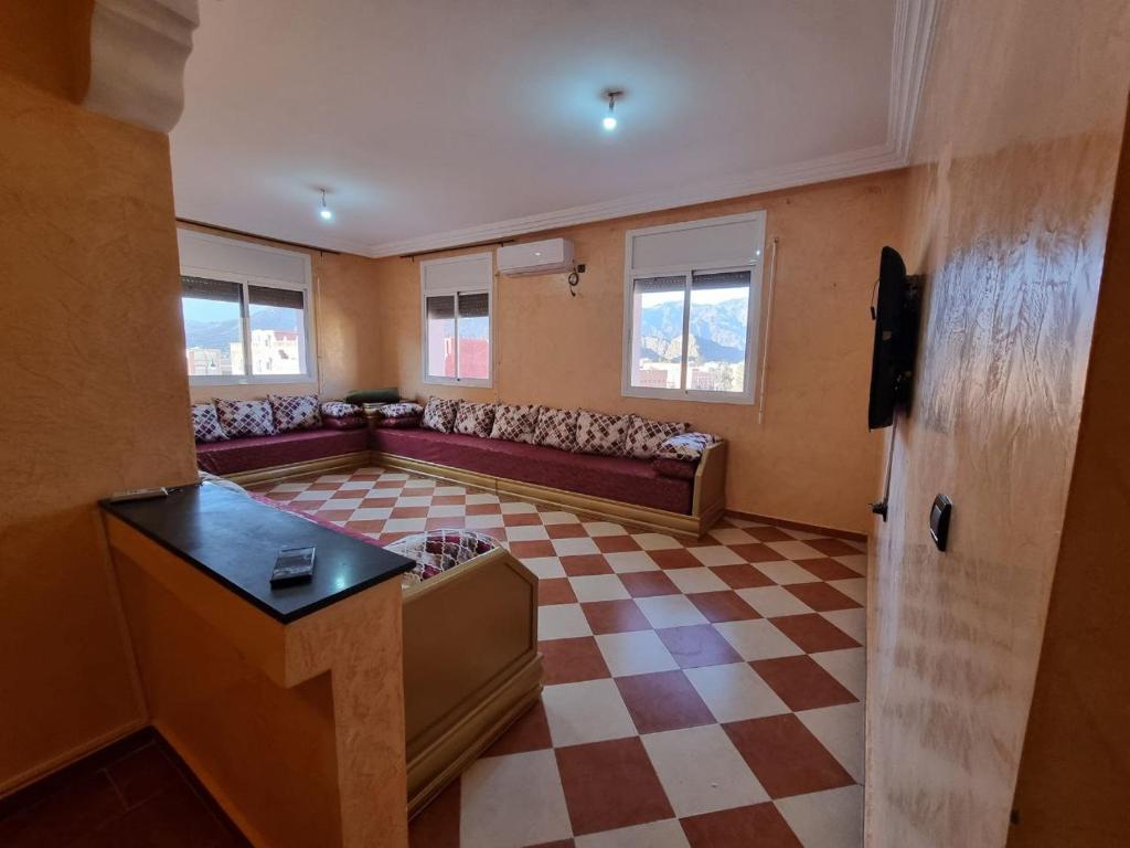 a living room with a couch and a checkered floor at Apartment in home tafraoute with terrace in Tafraout