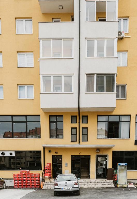 a car parked in front of a building at Apartman Stil in Bugojno