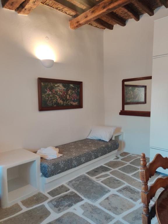 a room with a bed in the corner of a room at Neo-Traditional Sunrise Apartment in Ios Chora