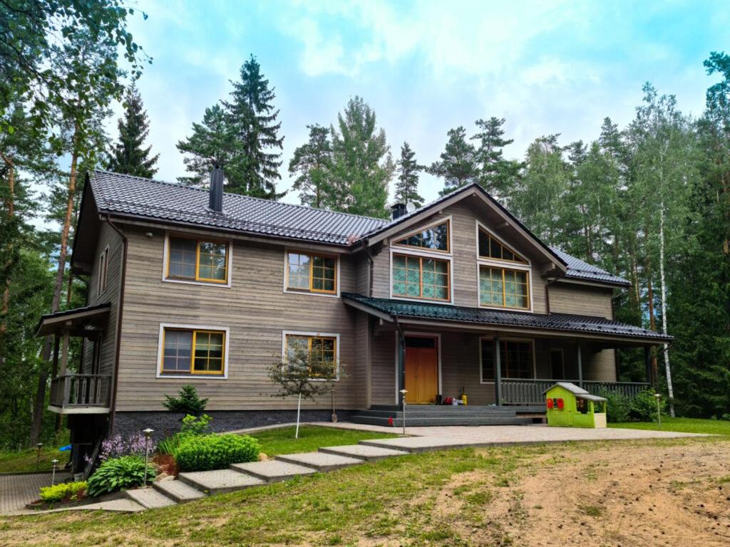 a house with a gambrel roof at Jaunakmeņi in Priežmale