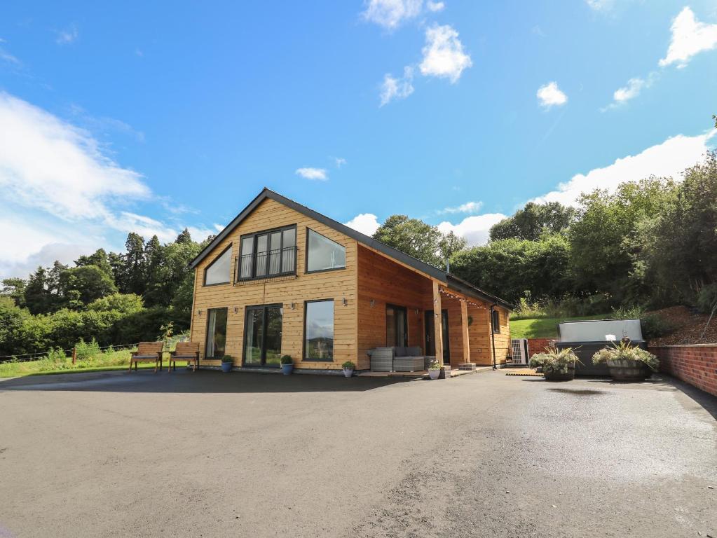 a house with a driveway in front of it at Harp Meadow in Presteigne