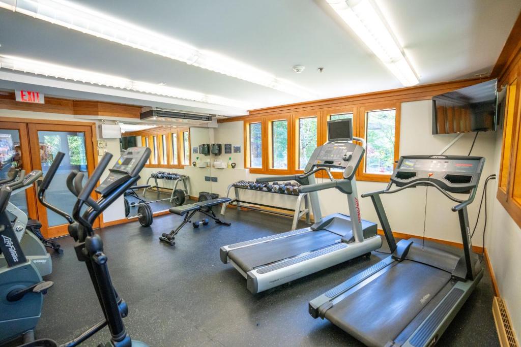 a gym with several tread machines in a room at Whistler Village Inn & Suites in Whistler