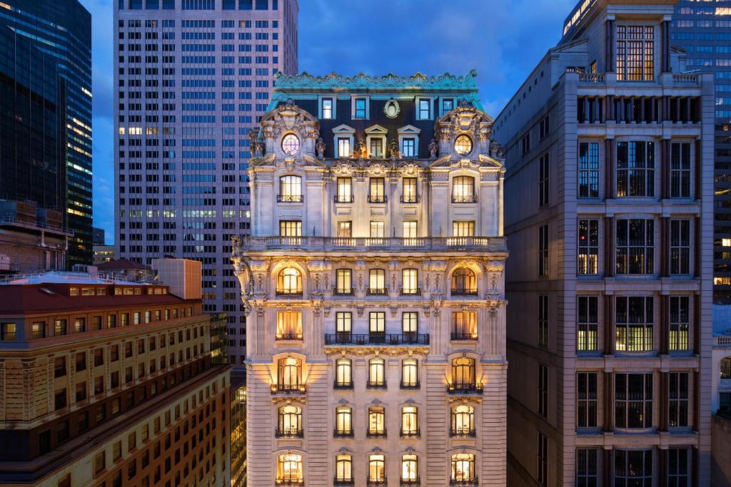 a tall building in the middle of some buildings at The St. Regis New York in New York