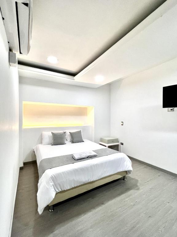Postel nebo postele na pokoji v ubytování Orbe Hotel Medellín