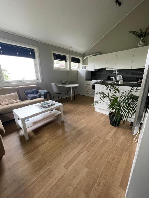 een woonkamer met een bank en een tafel bij Leilighet ved Ladestien in Trondheim