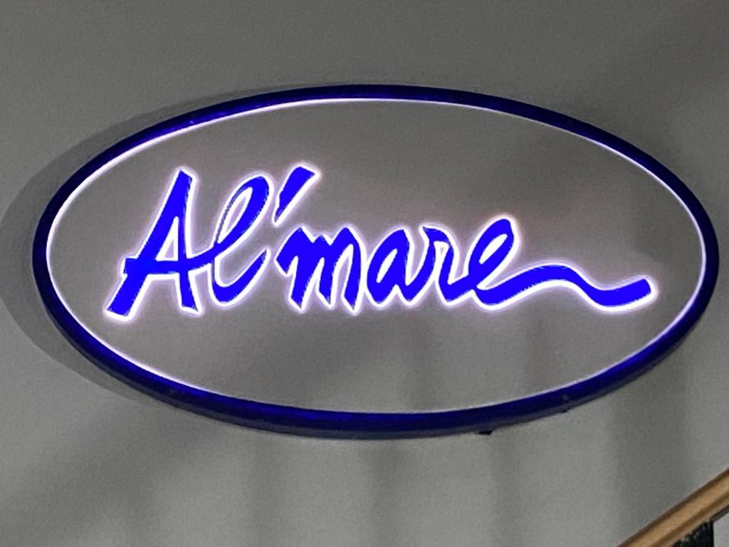 a neon sign that says ahme on a wall at Alojamiento Rural Al´Mare in Conil de la Frontera