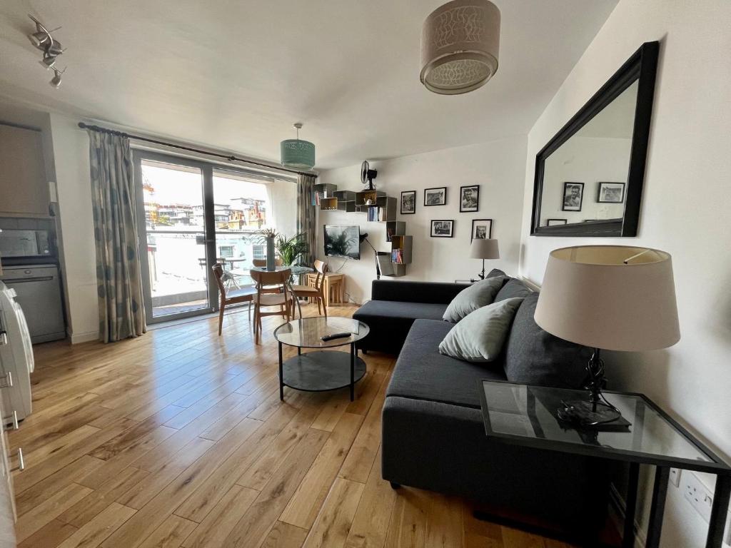 a living room with a couch and a table at Victoria suite in London